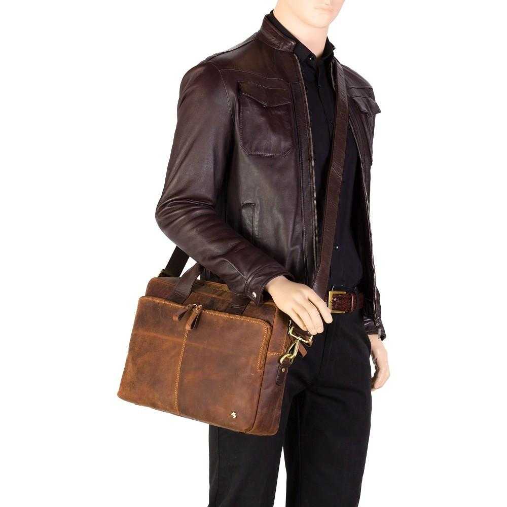 Man carrying Hugo 15" leather laptop briefcase in Havana tan with detachable shoulder strap and multiple compartments